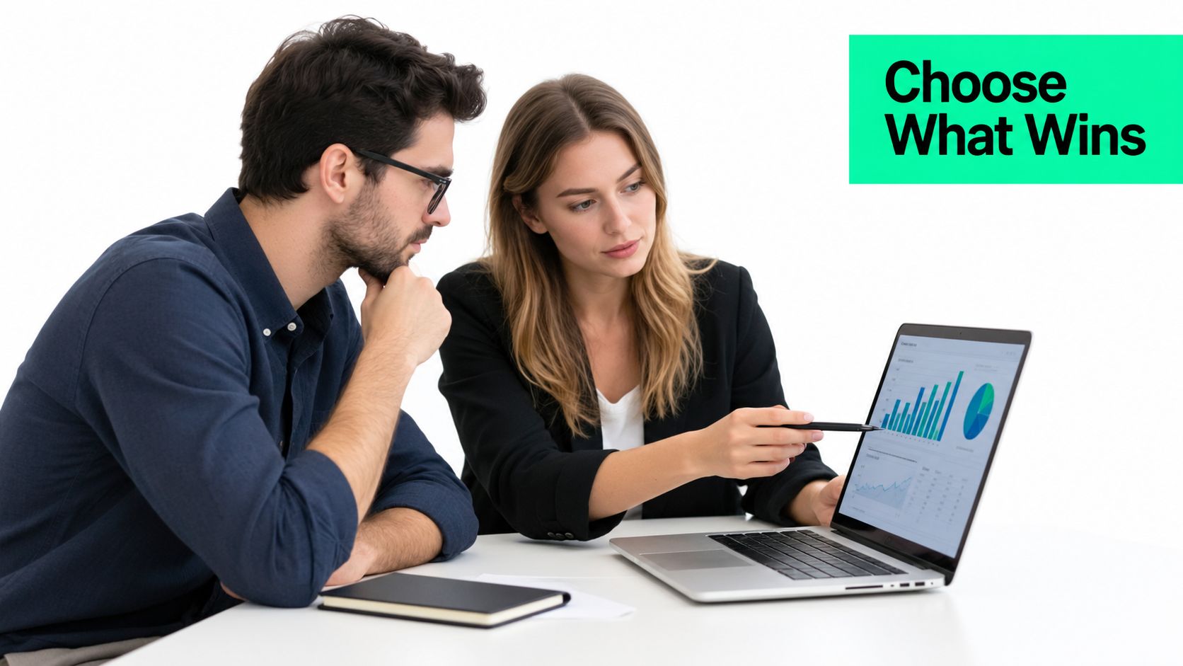 A professional man and woman collaborating on data analysis using a laptop computer at an office desk.